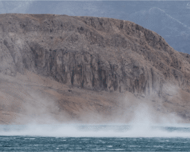 The Bura wind is a cold, dry wind that blows from the land toward the sea, often creating dramatic scenes like this one. In the image, a strong gust of bora lifts water from the surface of the sea, creating waves and mist above the blue water. The rugged landscape of Pag, with its sharp rocks, dominates the background, typical of this harsh yet beautiful island. The island of Pag is known for its unique nature and scenery, and the bora is a frequent phenomenon in this area, especially during the winter months. Its strength shapes not only the sea but also the plants and architecture on the island, and this shot vividly conveys the powerful interaction between the land, sea, and wind.